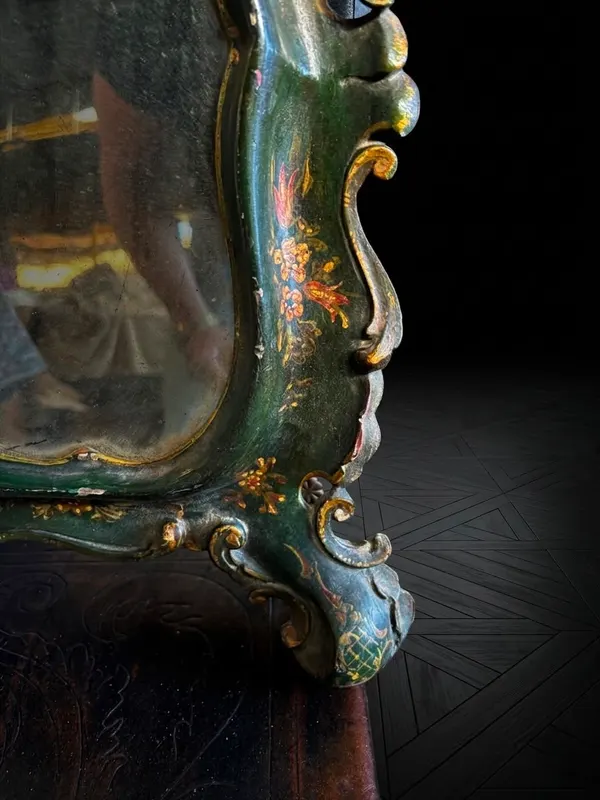 Detalle del marco del espejo veneciano con laca verde y flores policromadas